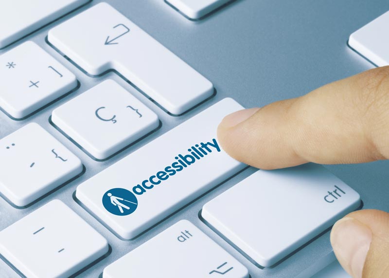 Person clicking laptop key entitled accessibility