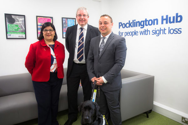 2 men and 1 woman standing together smartly dressed in Pocklington Hub for people with sight loss