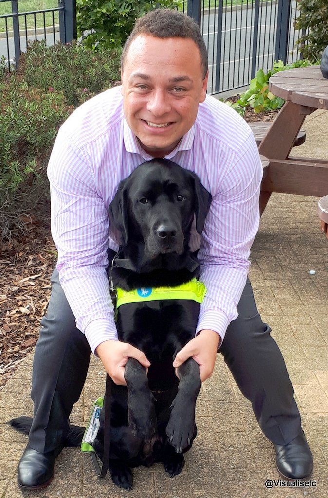Dan with his black lab guide dog Zodiac